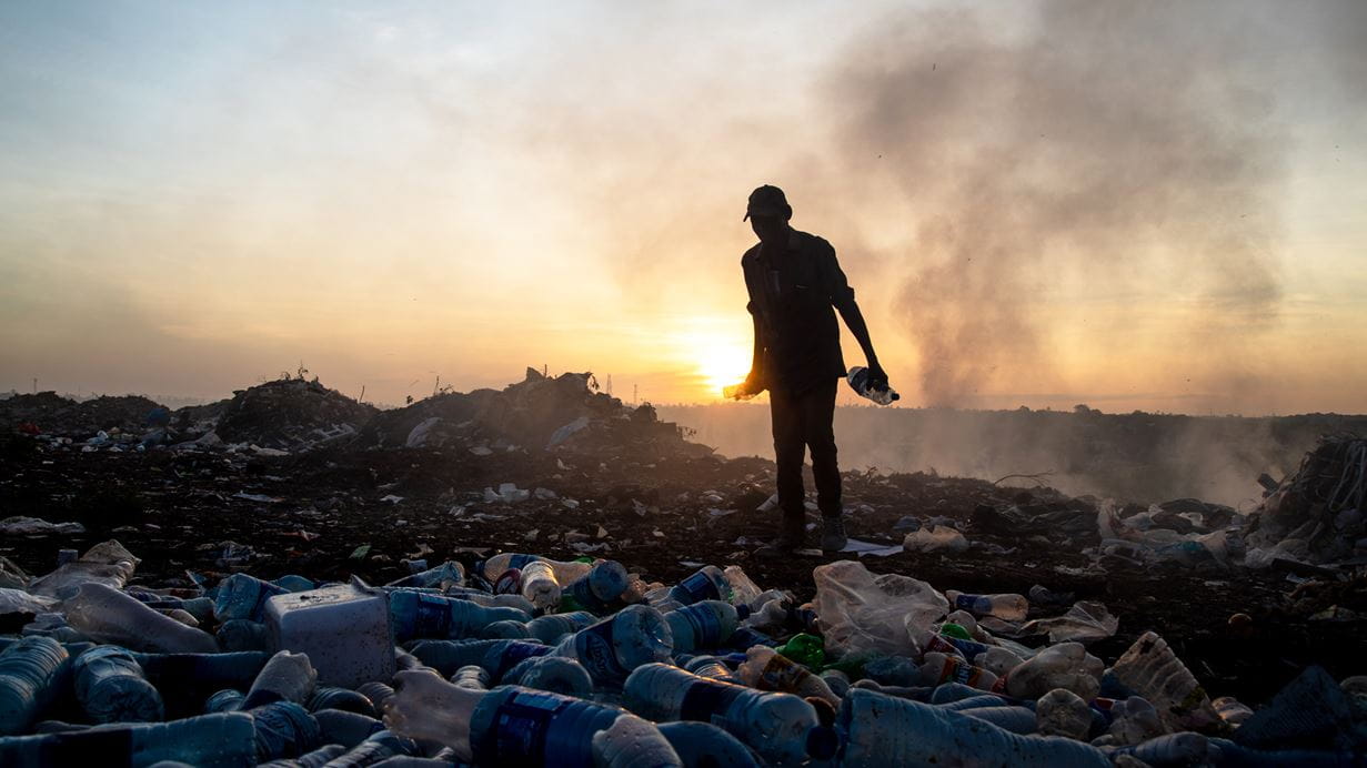 A waste picker collects plastic bottles in Dar es Salaam, Tanzania.