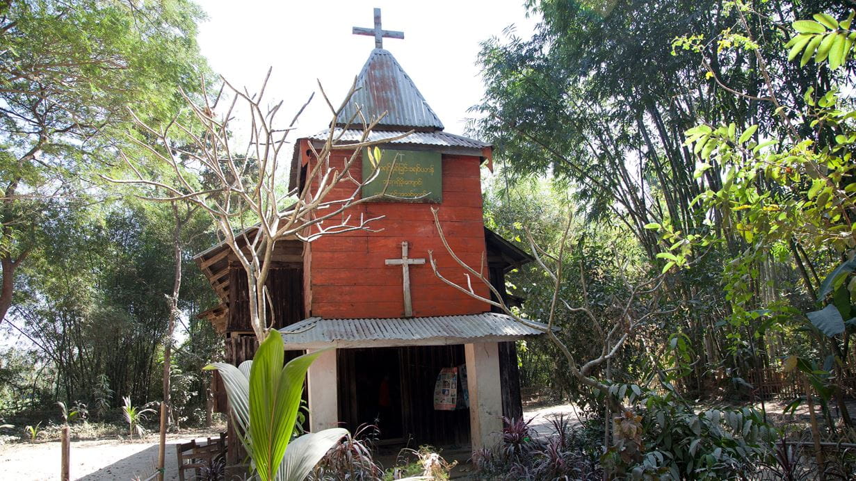 A church with trees and vegetation all around it