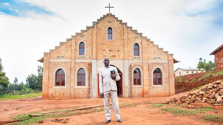 A man stood in front of a church building in Burundi