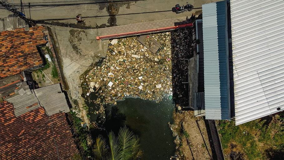 The plastic-choked River Tejipió that runs through this part of Recife in north-east Brazil is overwhelmed. Image: Mocah Films / Tearfund