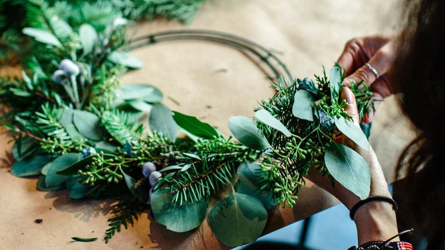 A person working on a Christmas wreath. Image: Hillary Ungson/Unsplash