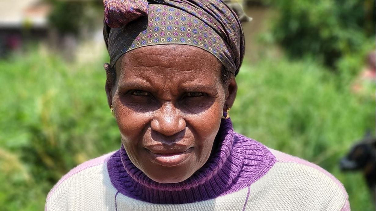 Roseline wears a patterned headscarf 