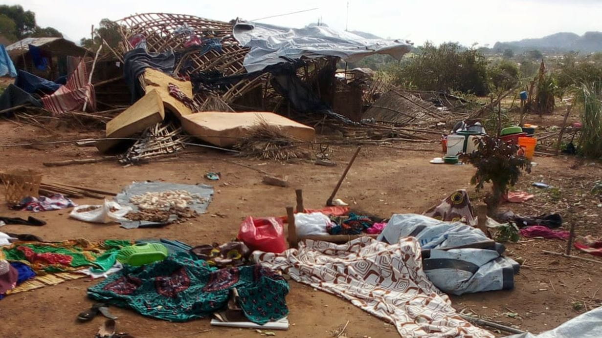 Household items and personal belongings lie strewn on the ground outside a collapsed house after Cyclone Chido.