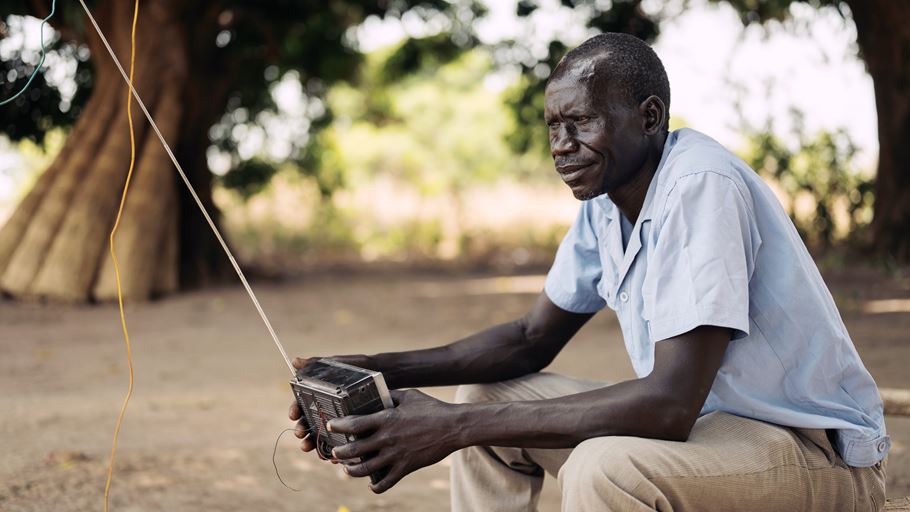 Julius sits on a bench and listens to his radio 