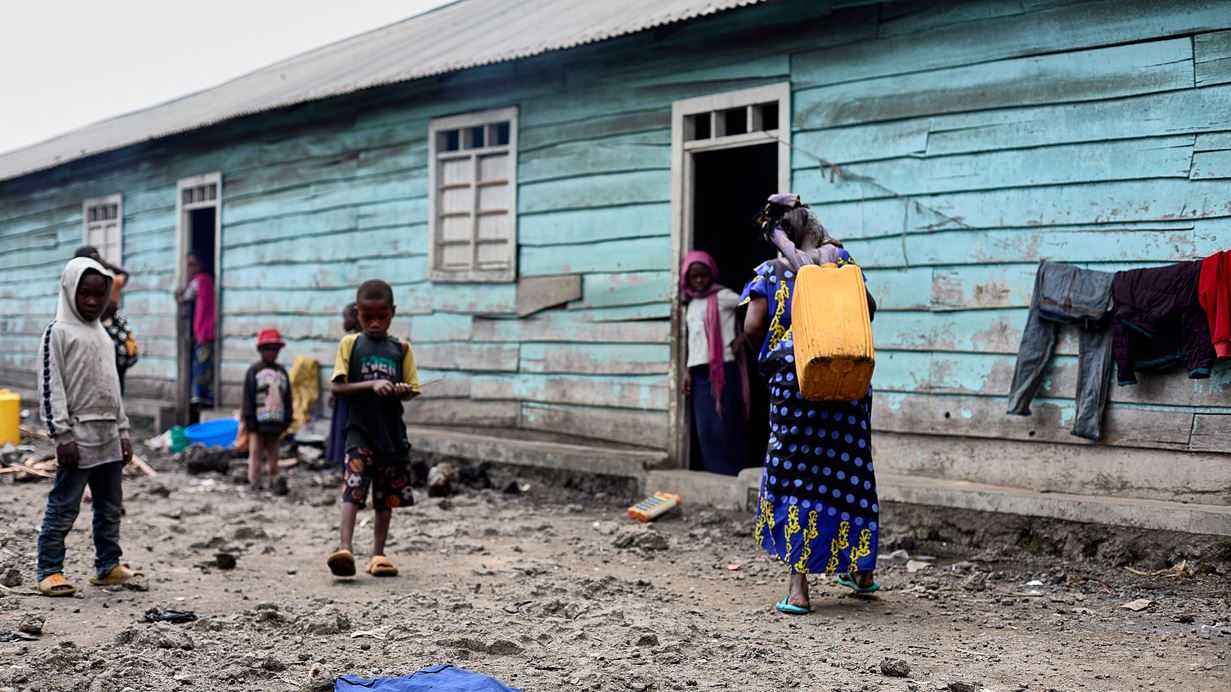 People outside a classroom that has become their temporary home in Goma