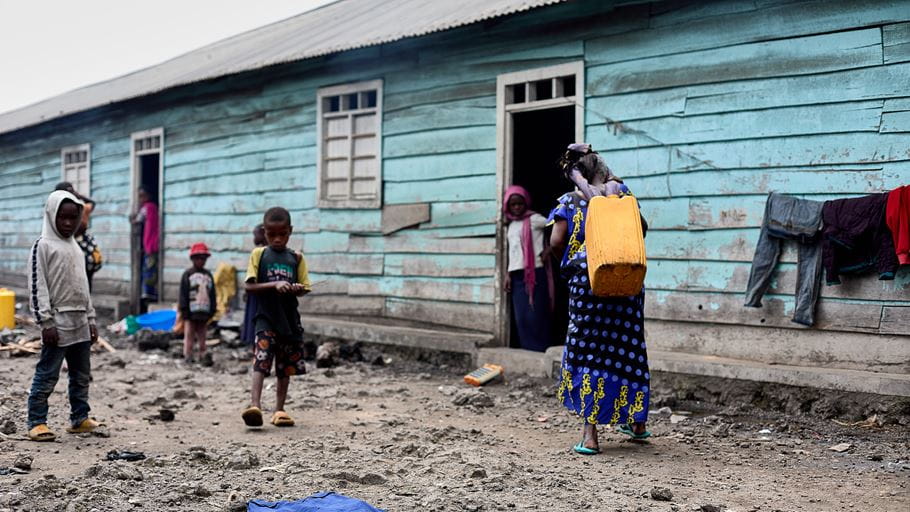 People outside a classroom that has become their temporary home in Goma