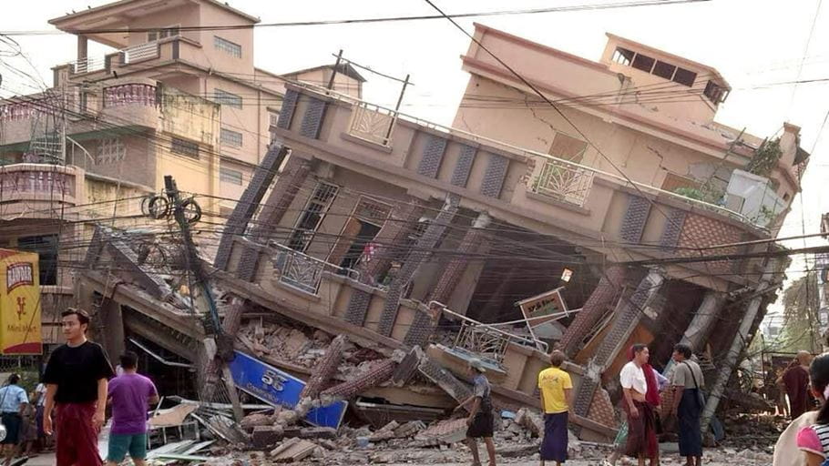 People gaze at a collapsed building in disbelief after earthquakes struck Myanmar on 28 March.