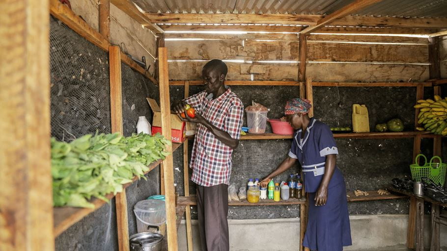 John and Helen in the charcoal-lined cool room storing produce to keep it fresh until they take it to market.