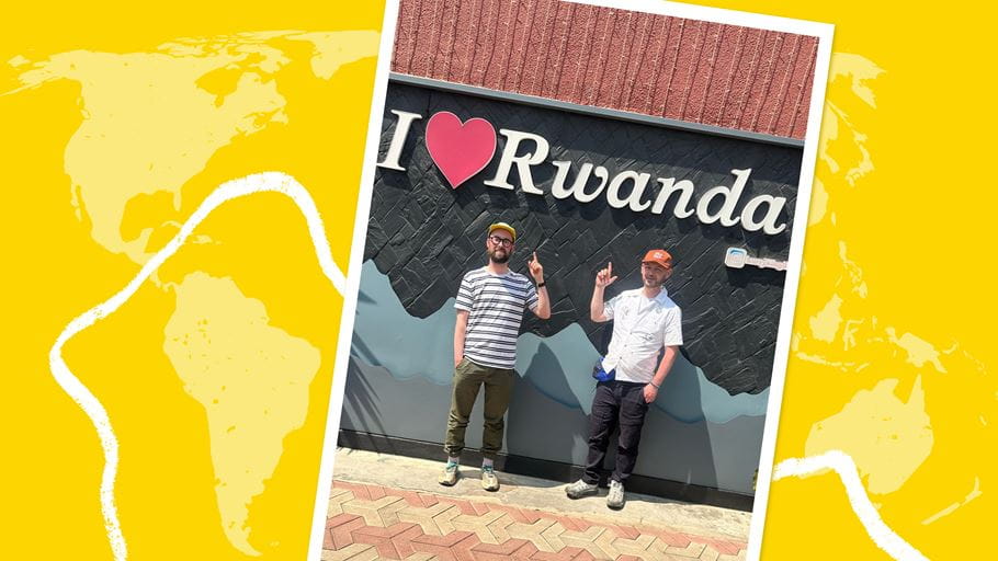 Two men pose in front of an "I [heart] Rwanda" sign, the photo is set against yellow world map background.