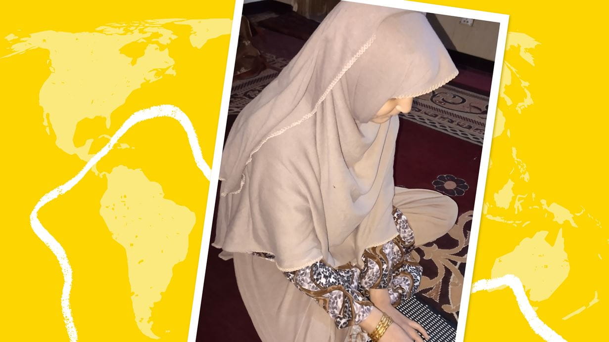Sania, a student in Afghanistan who is visually impaired, sits on a rug practicing her braille writing by placing pegs into a learning board. The photograph is overlayed on a world map graphic background.