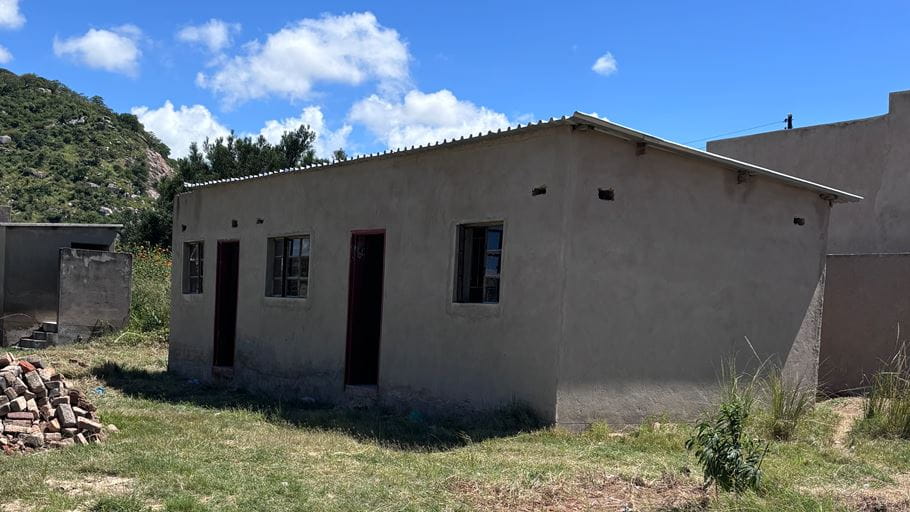 A two-roomed, one-story concrete local health clinic, recently built outside in the Dora community, Zimbabwe.